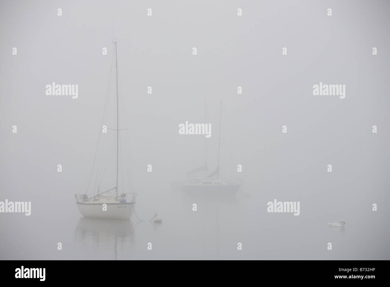 Mist over Lake Windermere in the Lake District UK Stock Photo