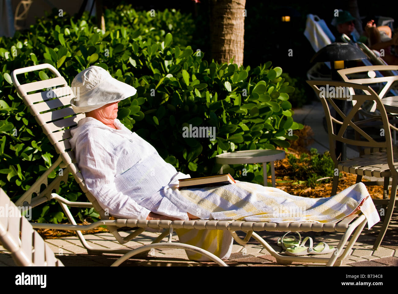 Palm Beach Shores , elderly women on sun loungers by pool sunbathing
