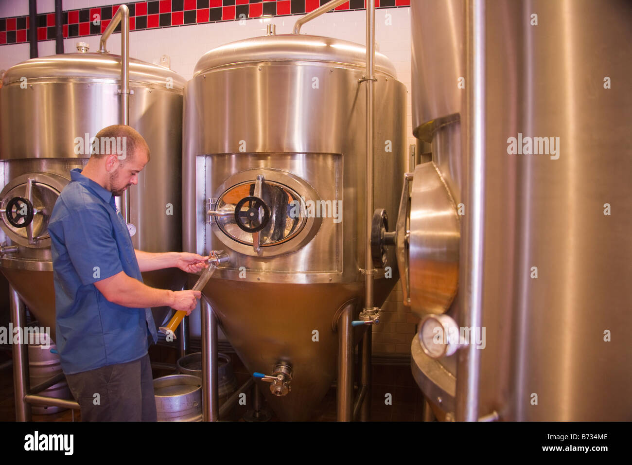 assistant brewer Tim Maddox checks beer Hollister Brewing Company