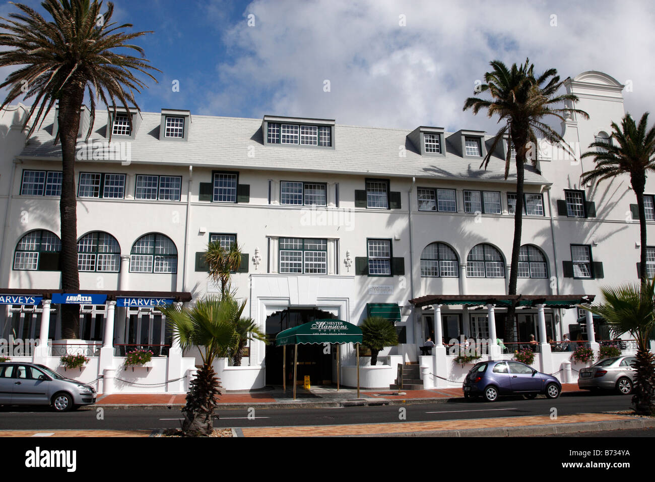 entrance of the winchester mansions hotel and harvey's bar along beach road sea point cape town south africa Stock Photo