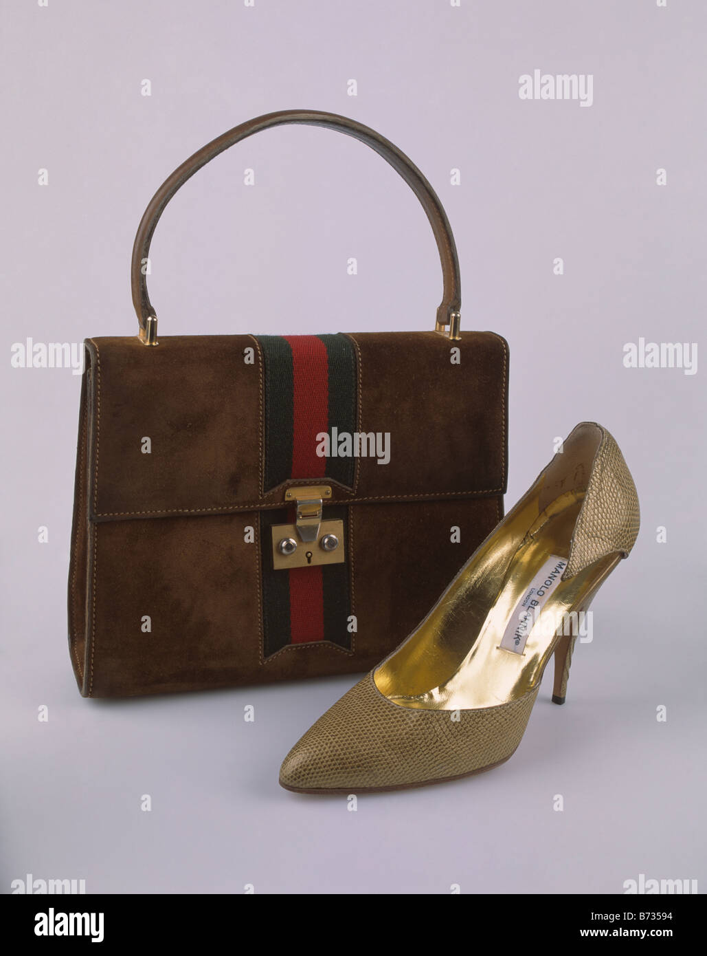 Close-up of black handbag and bronze silk Manolo Blahnik ladies high-heeled shoe Stock Photo