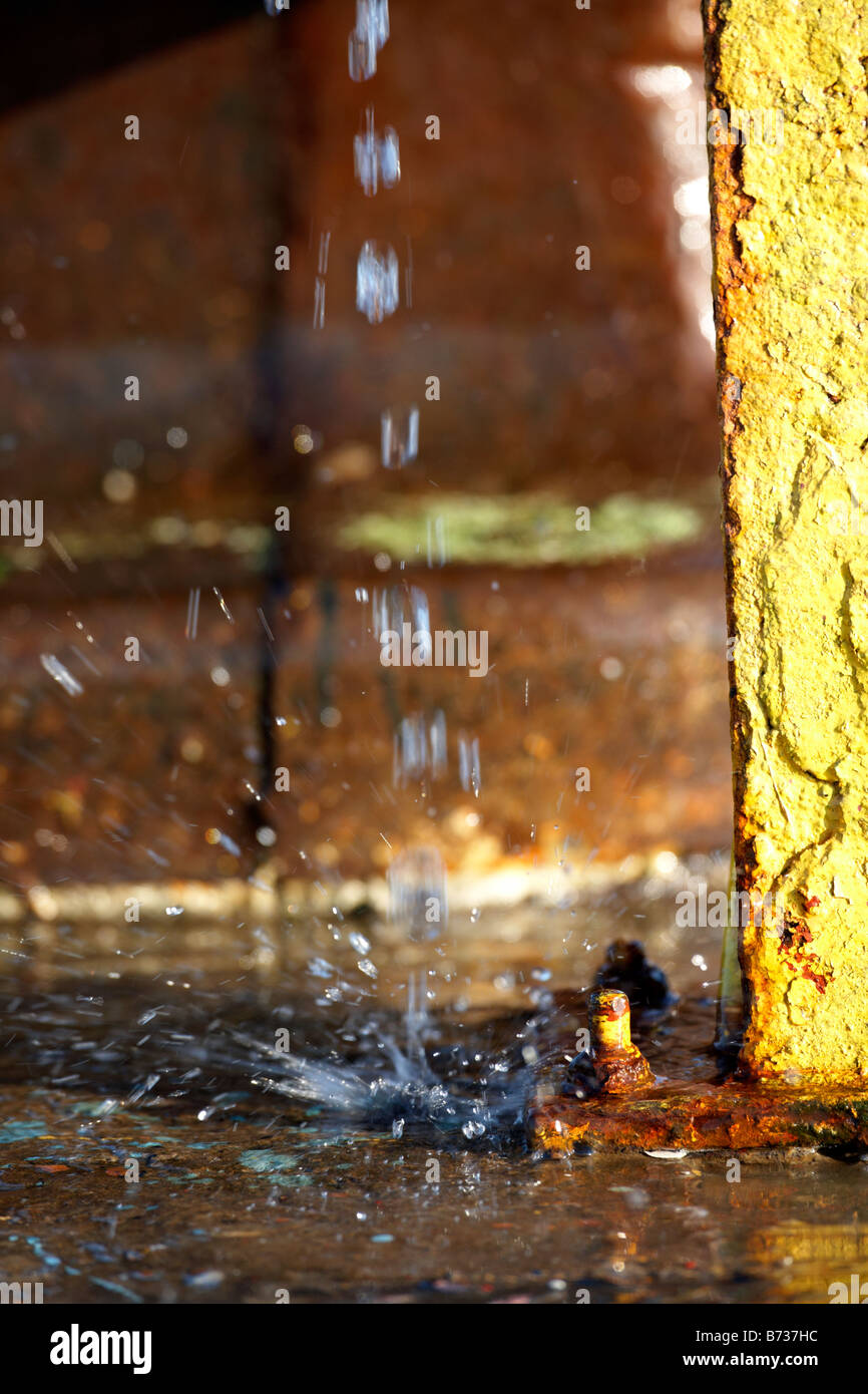 water dripping hitting concrete and making a splash county down Northern Ireland UK Stock Photo