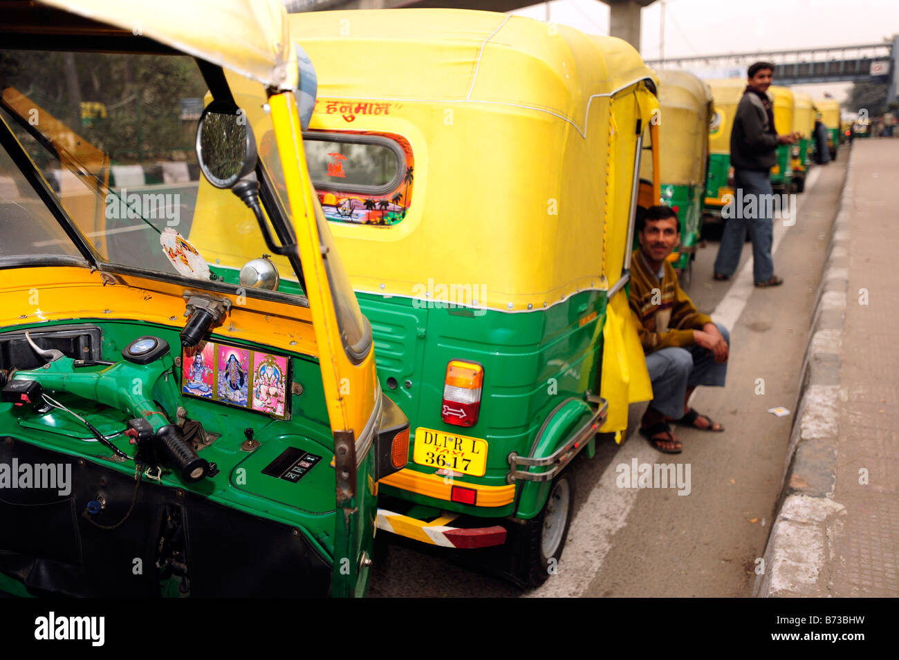 rickshaw taxi drivers queue to fill up at a petrol station during a nationwide petrol strike Stock Photo