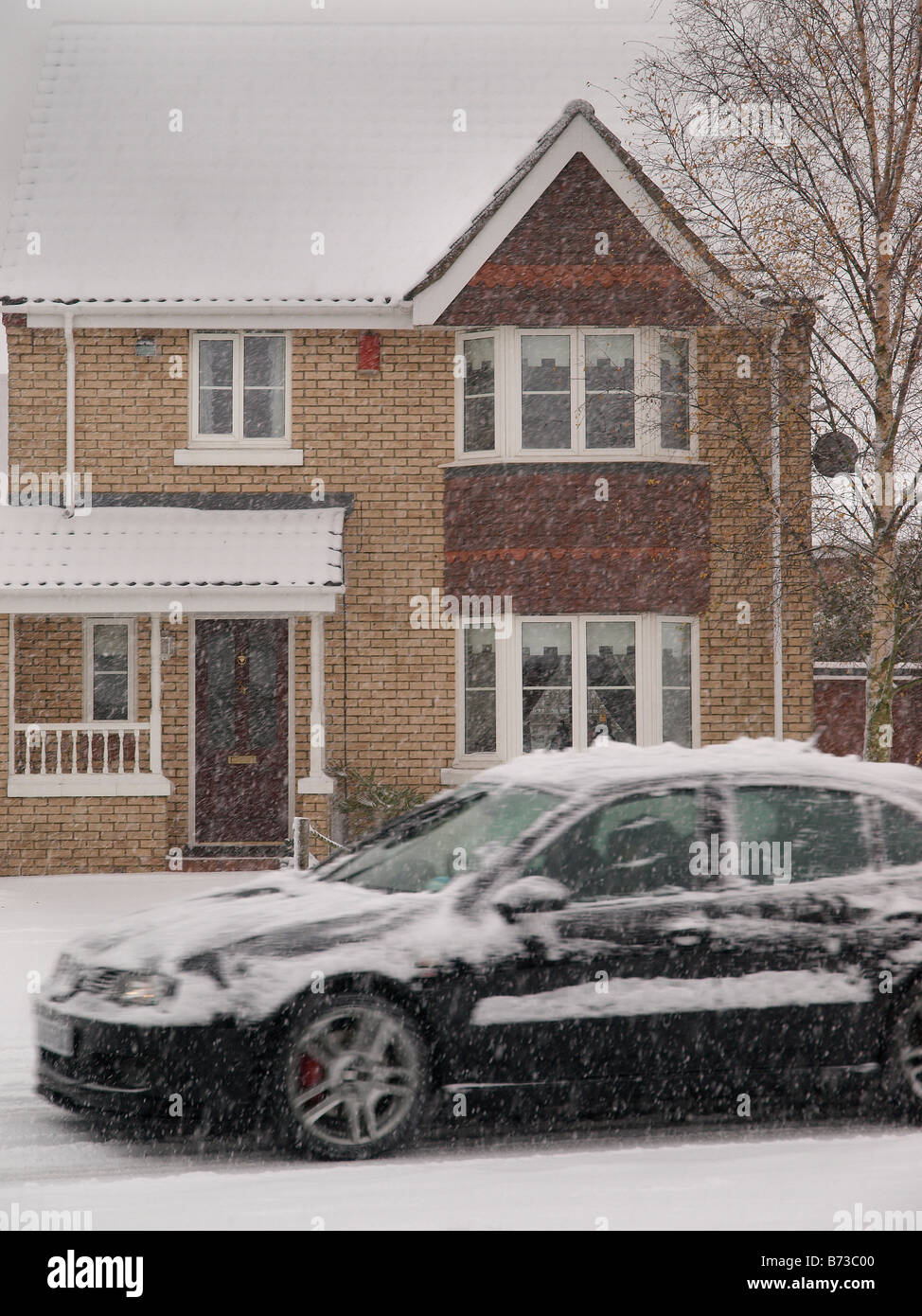 lifestyle picture,Black car COVERED WITH SNOW moving through snowfall