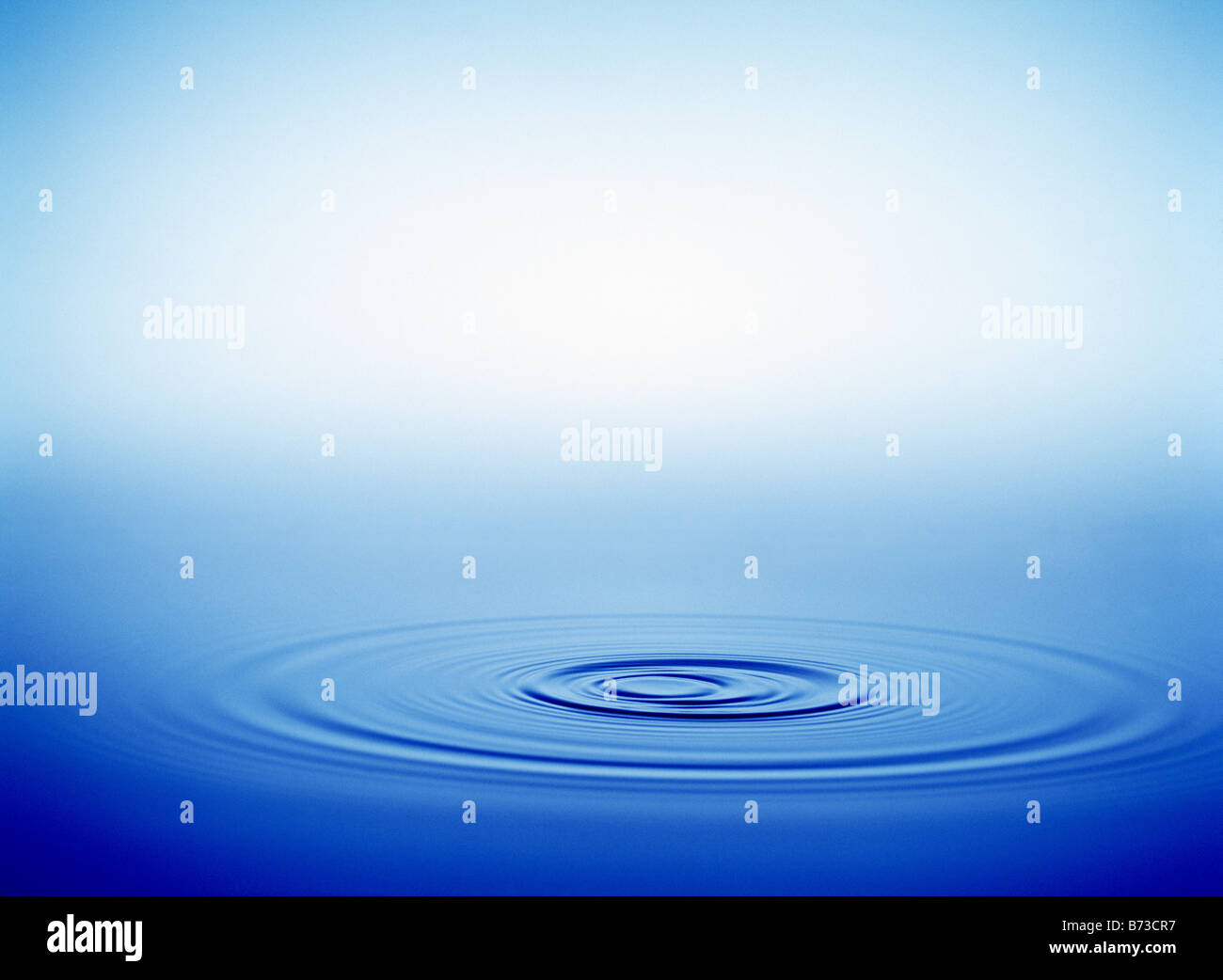 water ripples with a gradated blue background Stock Photo