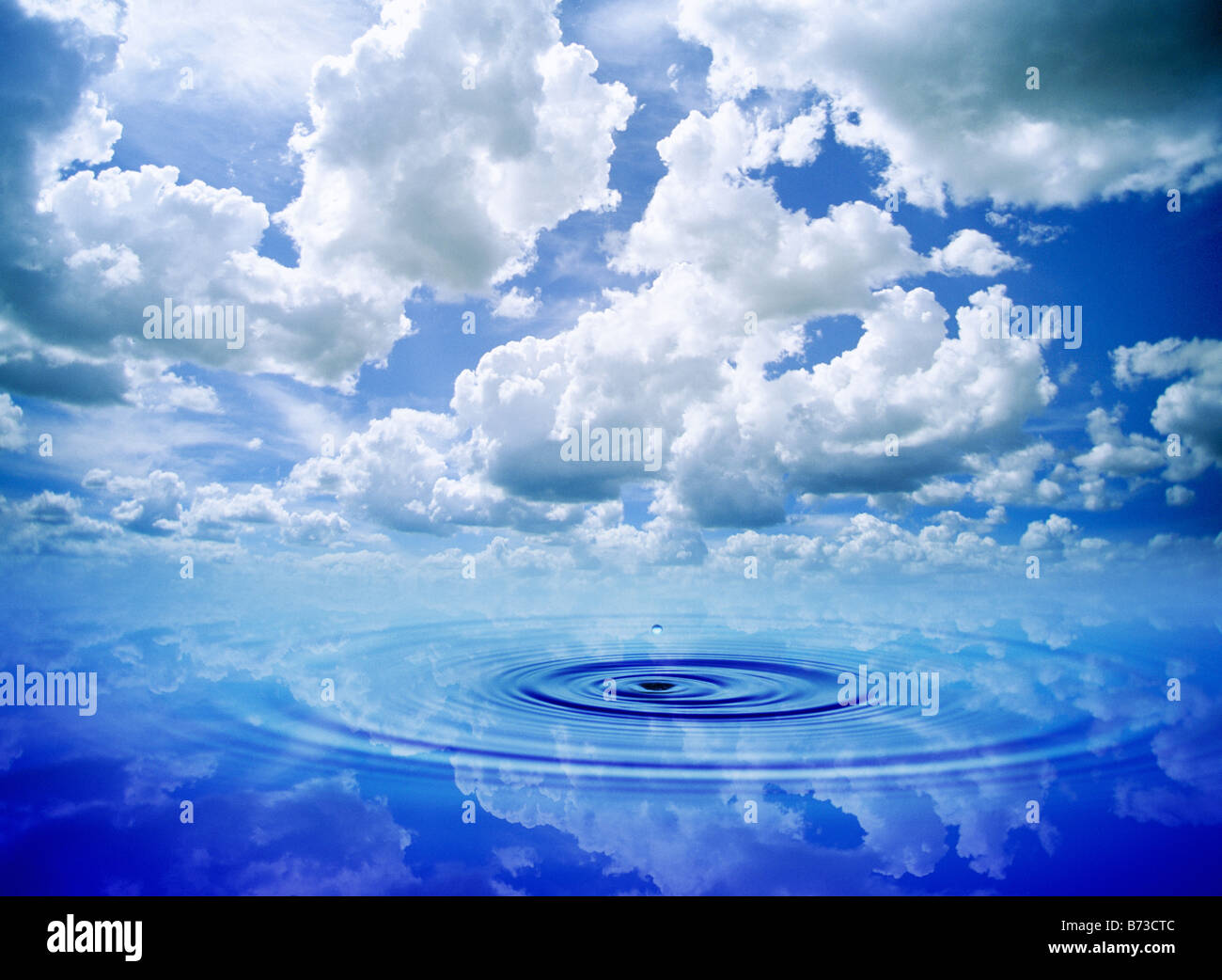 water ripples with a gradated blue cumulus cloud background Stock Photo