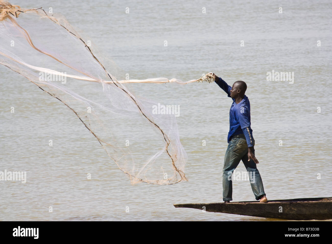 Man using net to fish in Bani River outside of Djenne, Mali Stock Photo