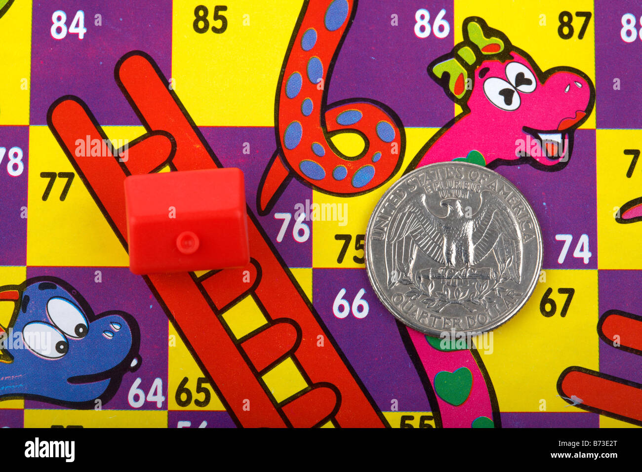 one us quarter dollar 25c coin and toy red house on a snakes and ladders board with house on ladder and quarter on snake property real estate prices Stock Photo