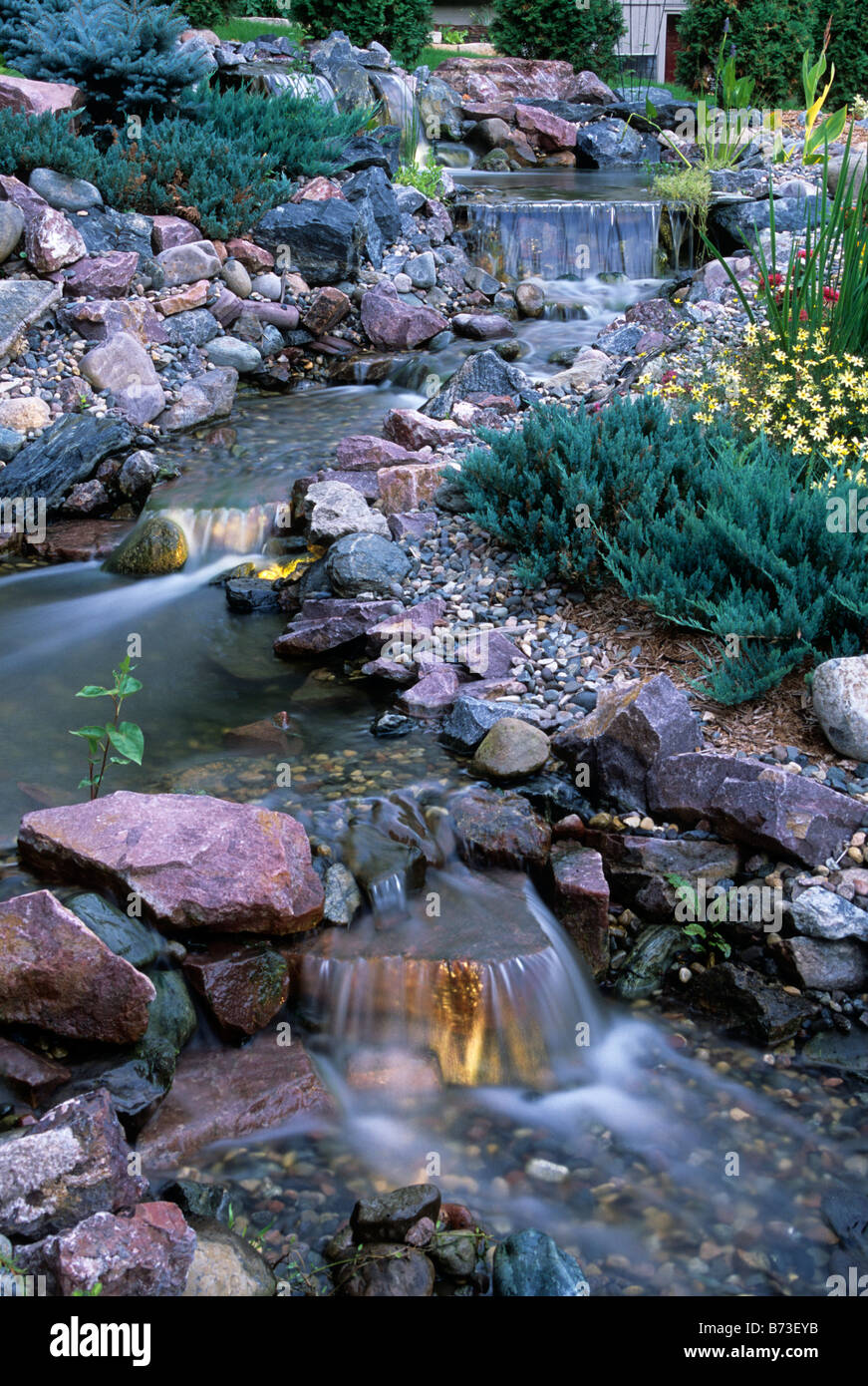 CASCADING WATERFALLS IN BACKYARD GARDEN LIT FROM UNDERWATER BY FIBER OPTIC  LIGHTING. MINNESOTA; MID-SUMMER Stock Photo - Alamy, image size:871x1390