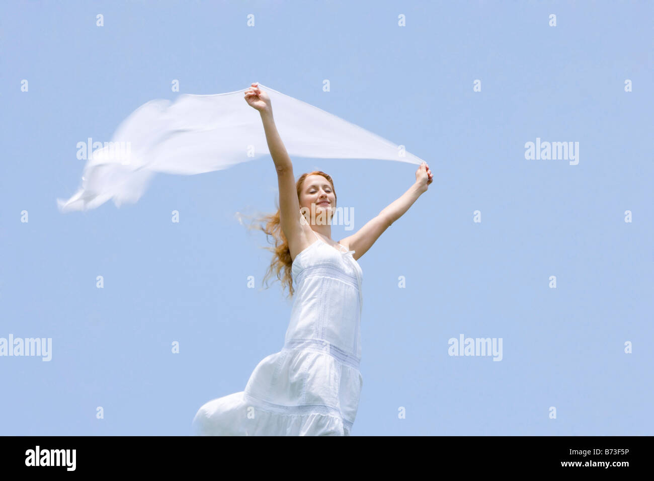 Woman holding shawl against wind Stock Photo