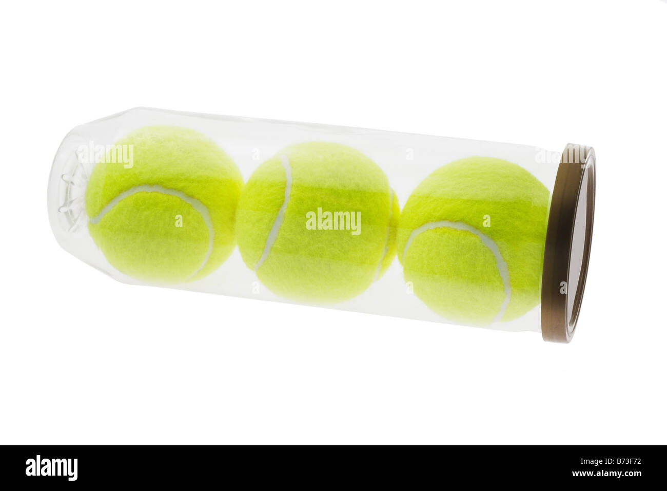 Three new yellow tennis balls in plastic container on white background