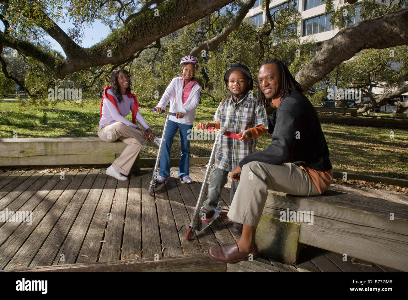 Young African American family outdoors in park Stock Photo - Alamy