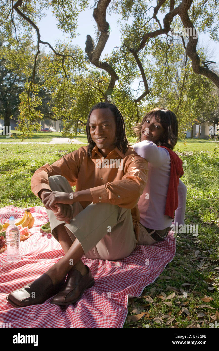 African American couple having a picnic outdoors in park Stock Photo