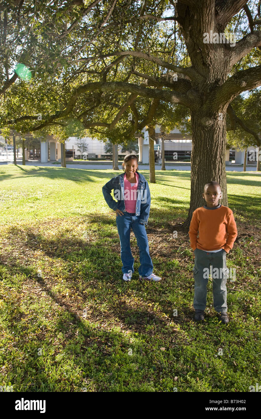 African American girl and boy standing in park Stock Photo - Alamy