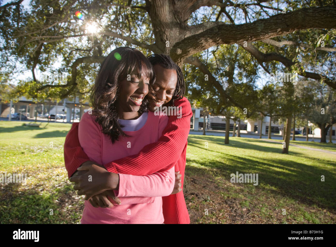 Young African American couple outdoors hugging in the park Stock Photo ...