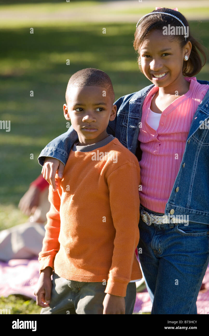 African American boy and girl standing in park Stock Photo - Alamy