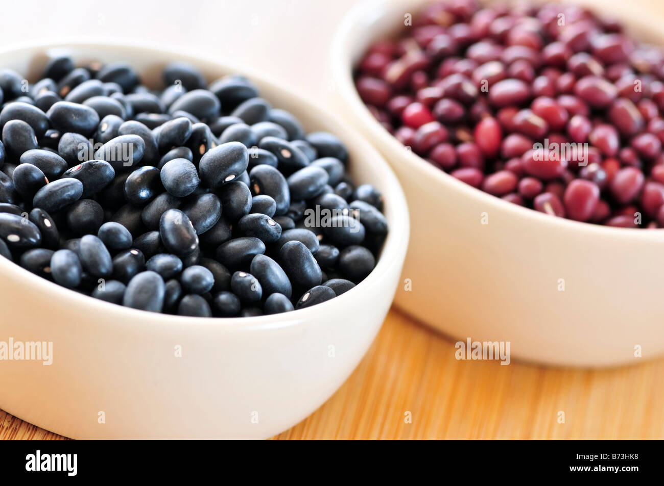 Dry black and red adzuki beans in bowls Stock Photo
