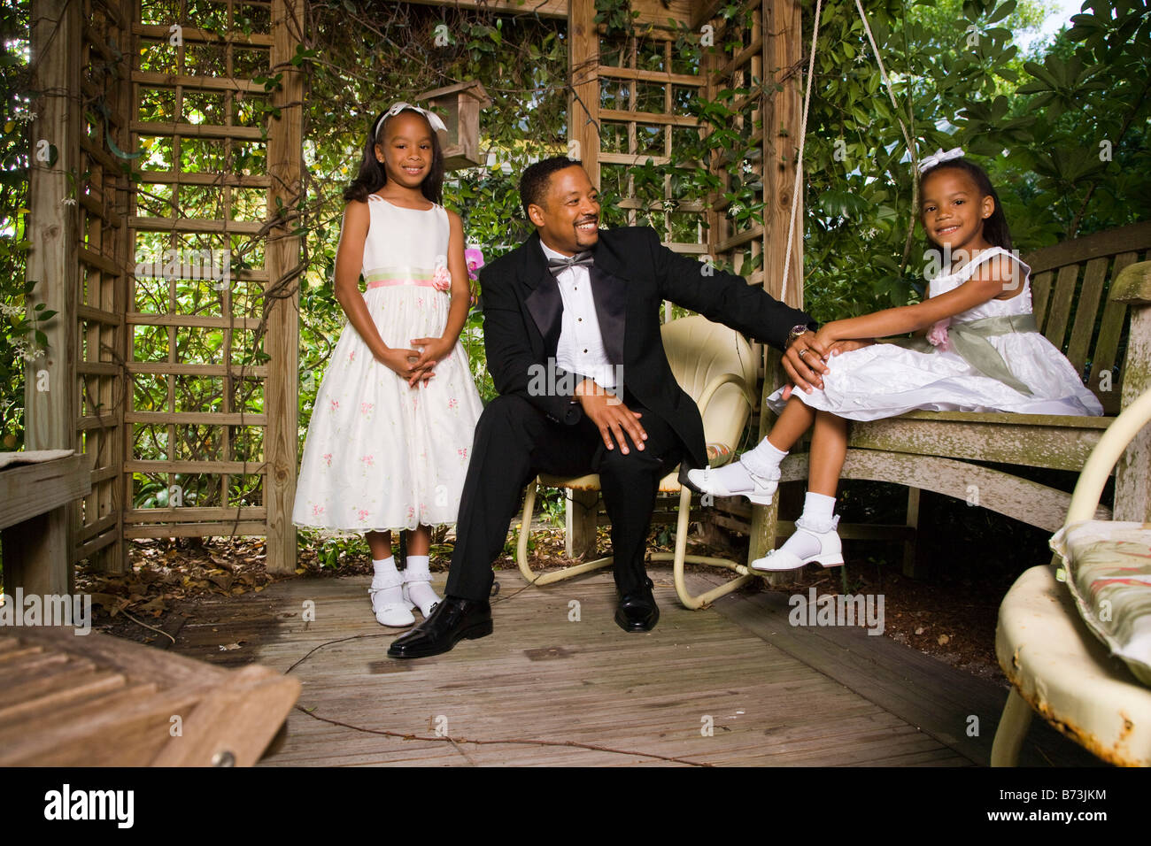 Happy African American Groom With Flower Girls In Gazebo On Wedding