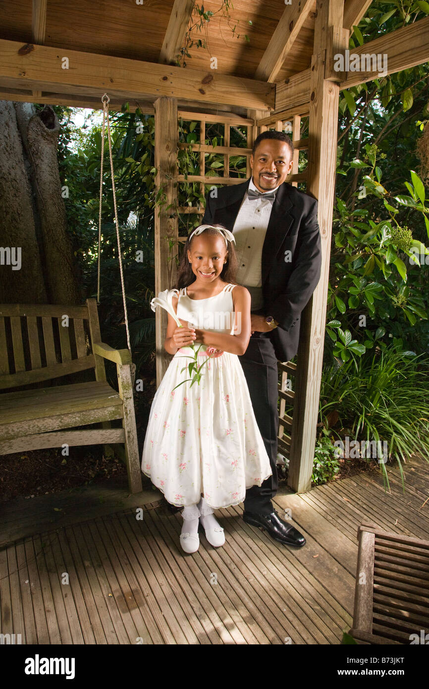 Happy African American groom with flower girl in gazebo on wedding day Stock Photo Alamy