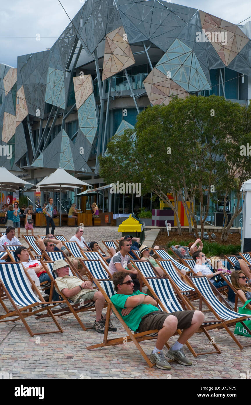 Australians watching test cricket on a large screen in Federation Square Melbourne Stock Photo