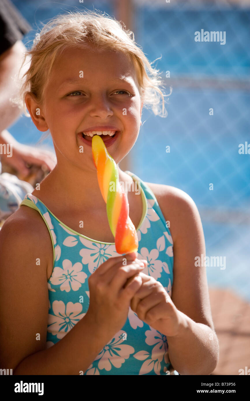 Closeup of girl in swimsuit licking popsicle Stock Photo - Alamy