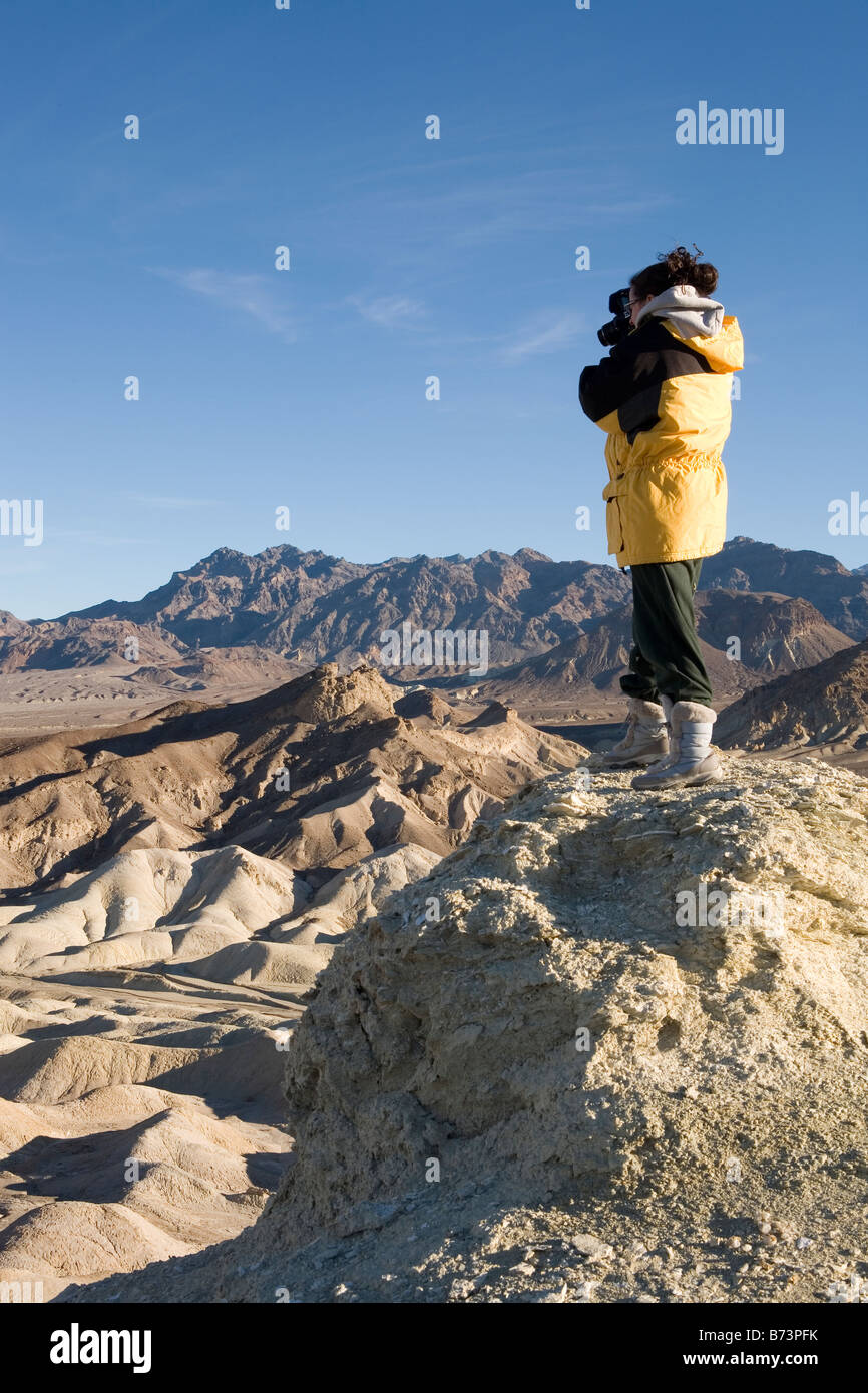 young woman hiker taking a photo in death valley national park usa ...