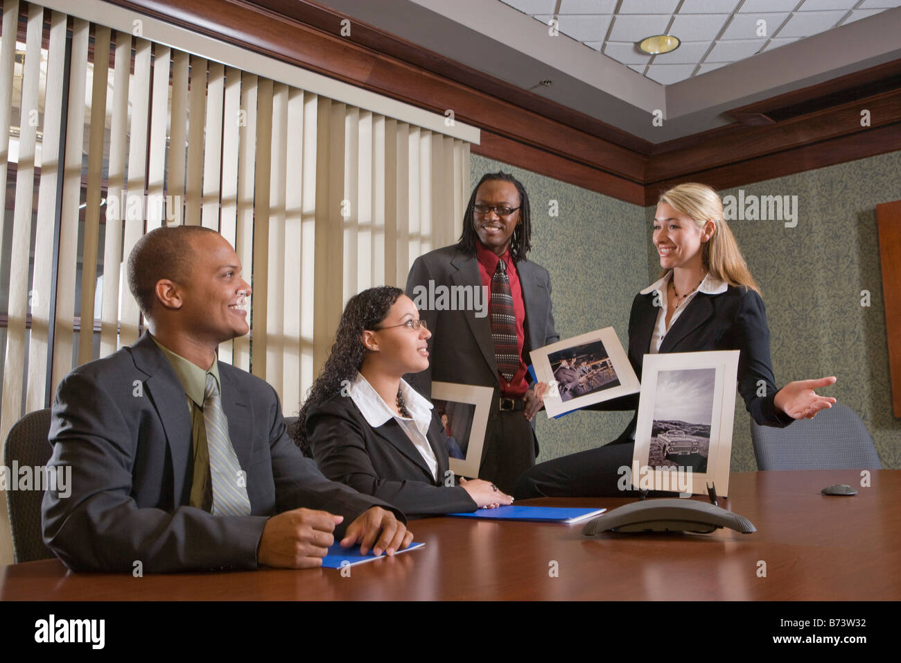 Multi-racial businesspeople meeting in boardroom, watching presentation Stock Photo