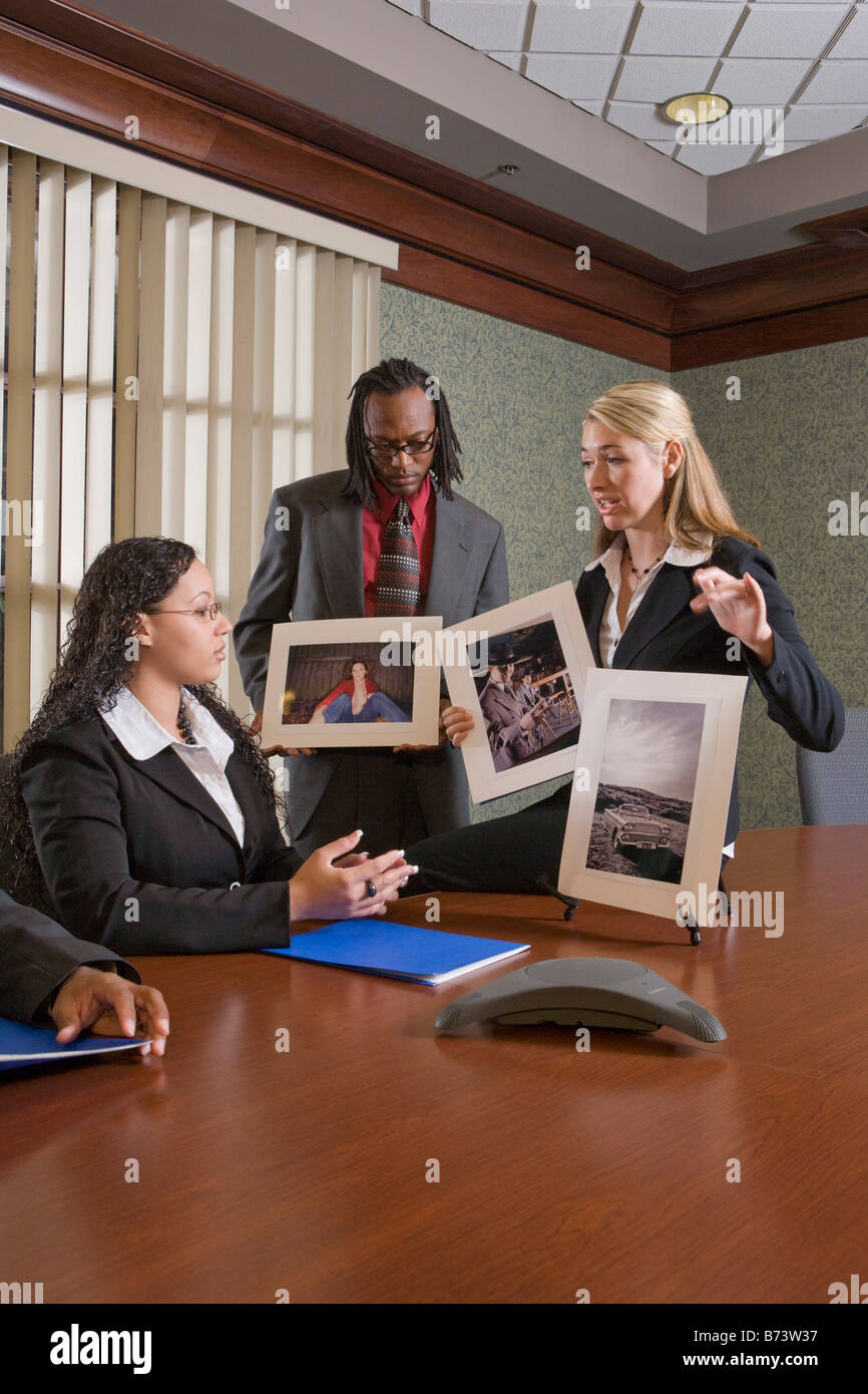 Multi-racial businesspeople meeting in boardroom watching presentation Stock Photo