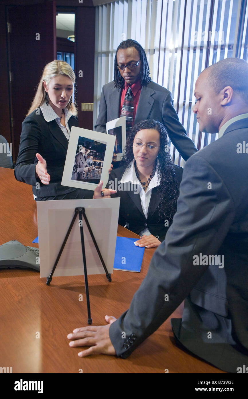 Multi-racial businesspeople meeting in boardroom watching presentation Stock Photo