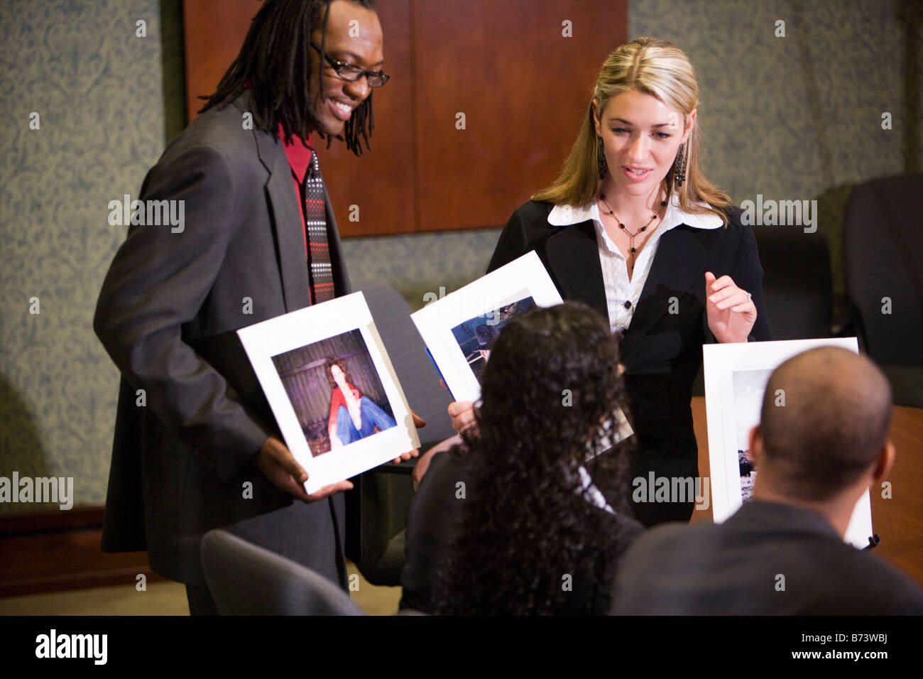 Multi-racial businesspeople presenting marketing project in boardroom Stock Photo