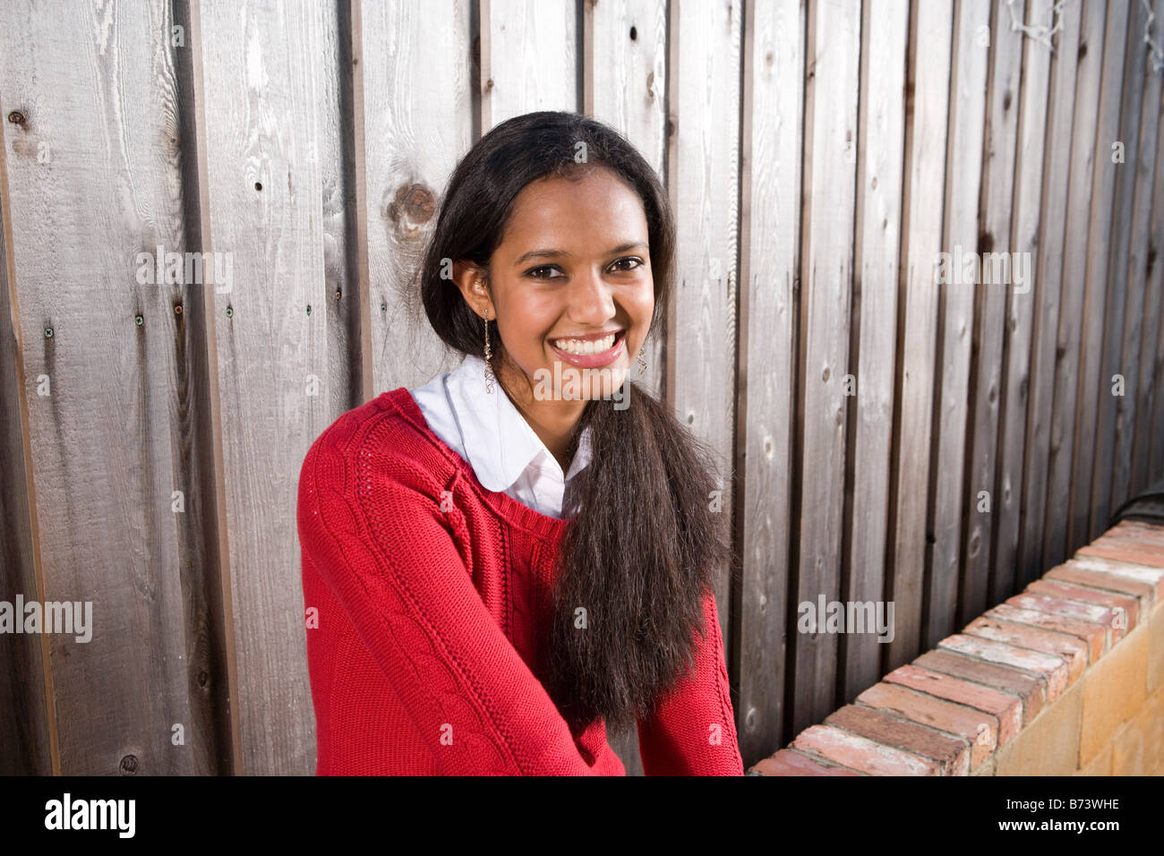 Indian teenage girl sitting outside, close up Stock Photo