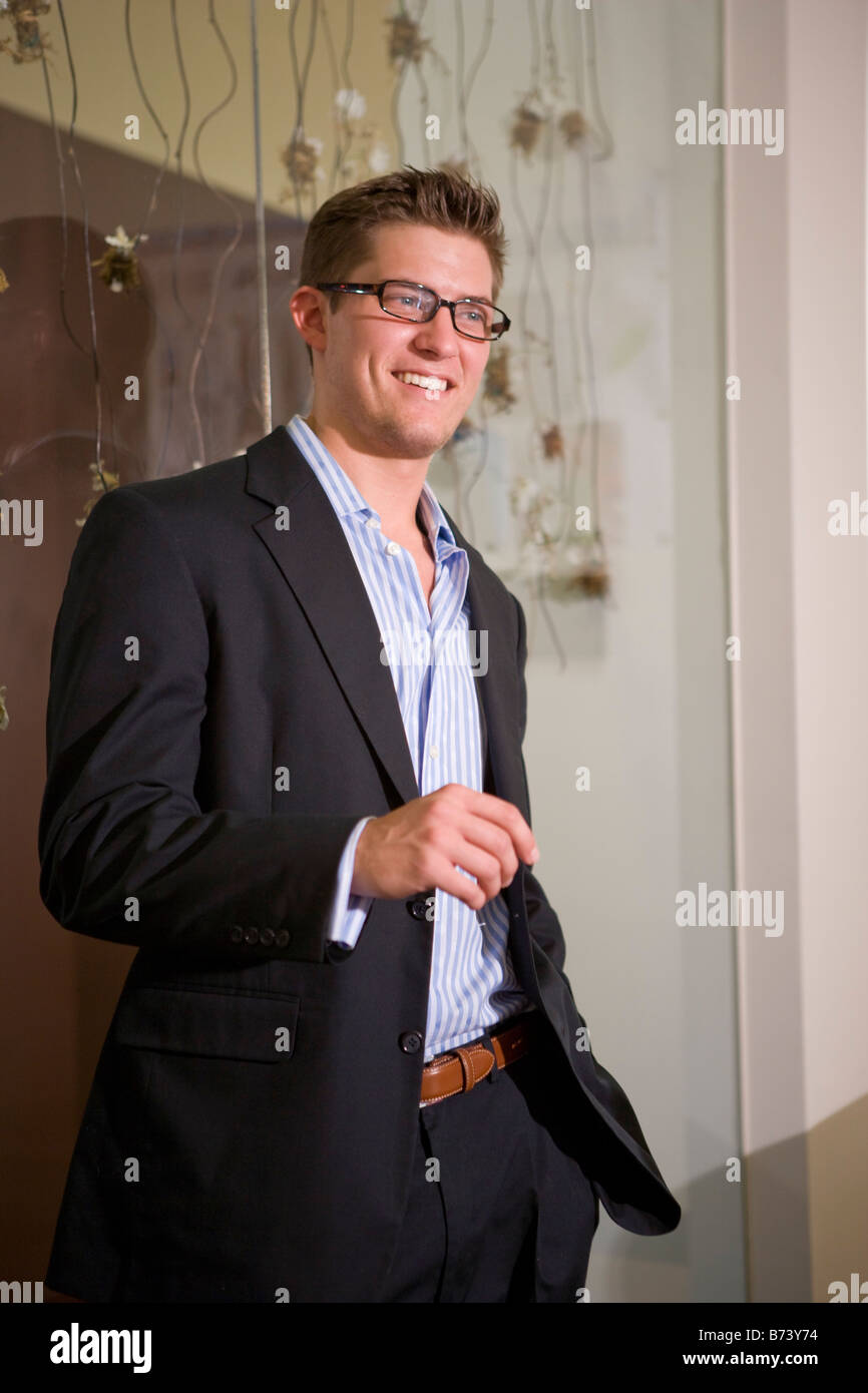 Handsome young man in jacket wearing eyeglasses, smiling Stock Photo ...