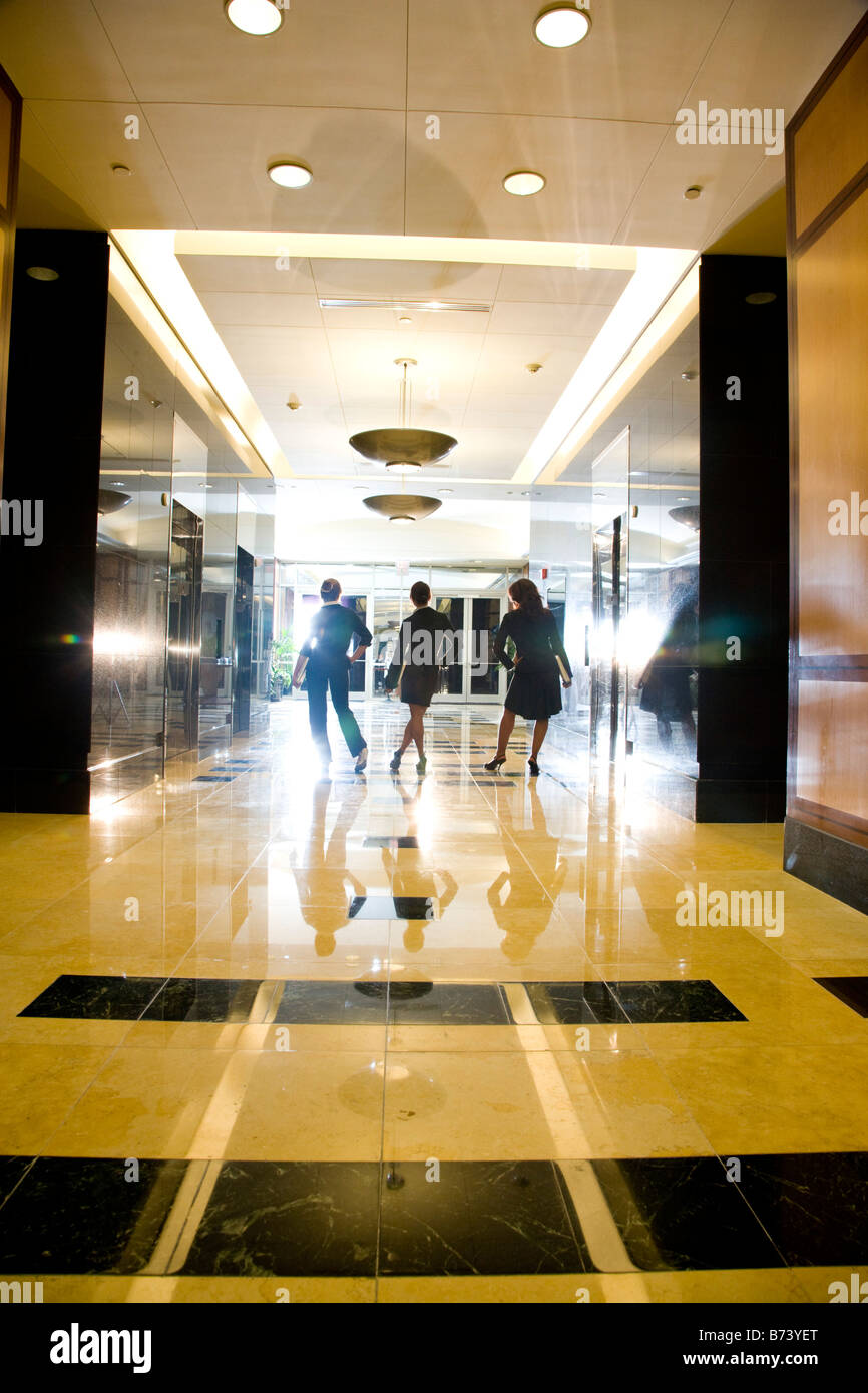Multi-ethnic office workers waiting in office building lobby for elevator Stock Photo