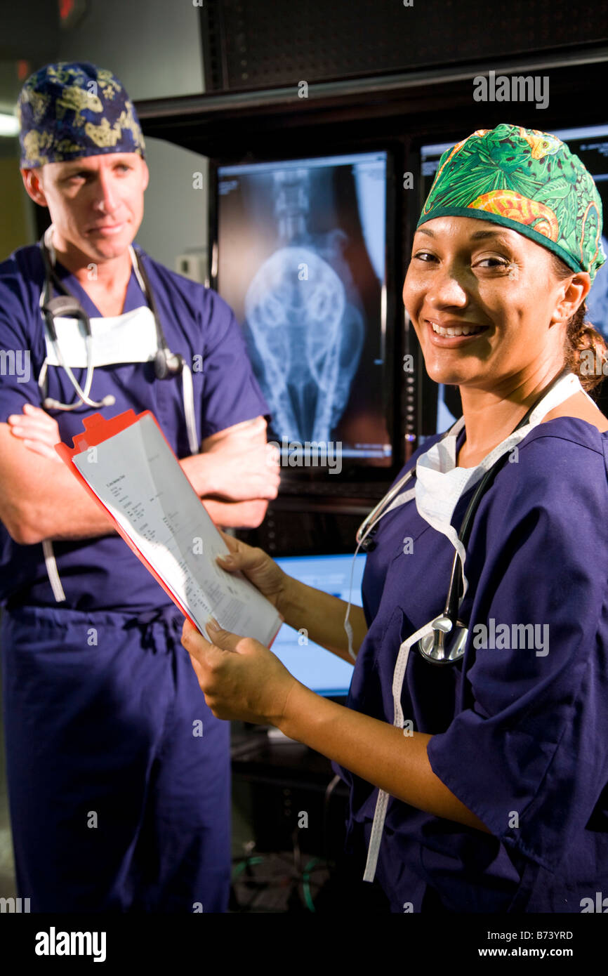 Veterinarians discussing medical records with animal x-rays in ...