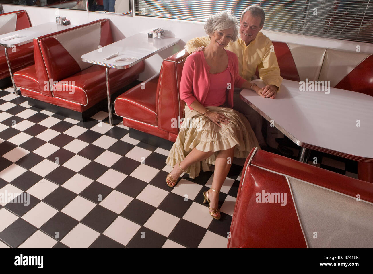 Couple sitting in restaurant booth hires stock photography and images