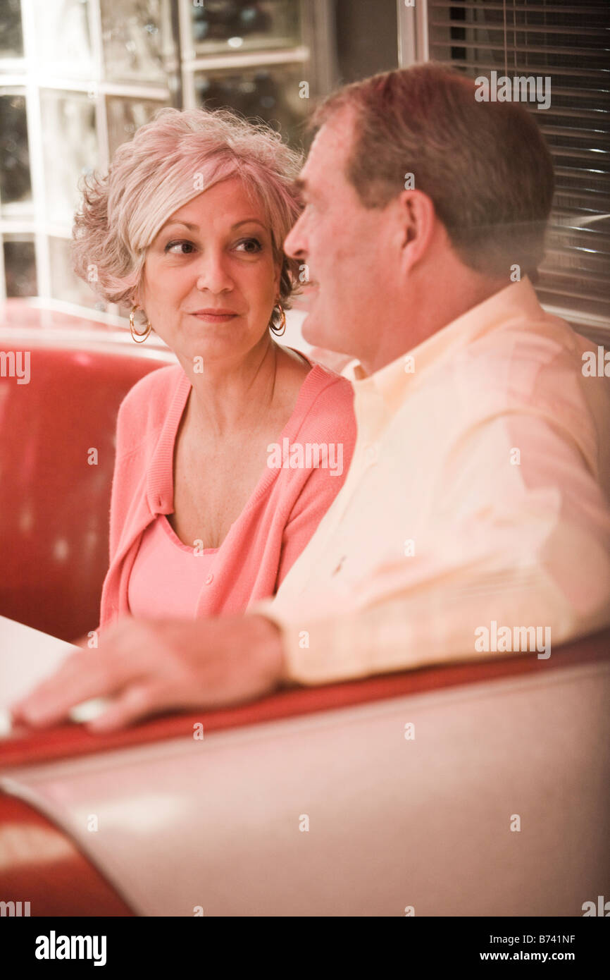 Couple sitting in restaurant booth hires stock photography and images