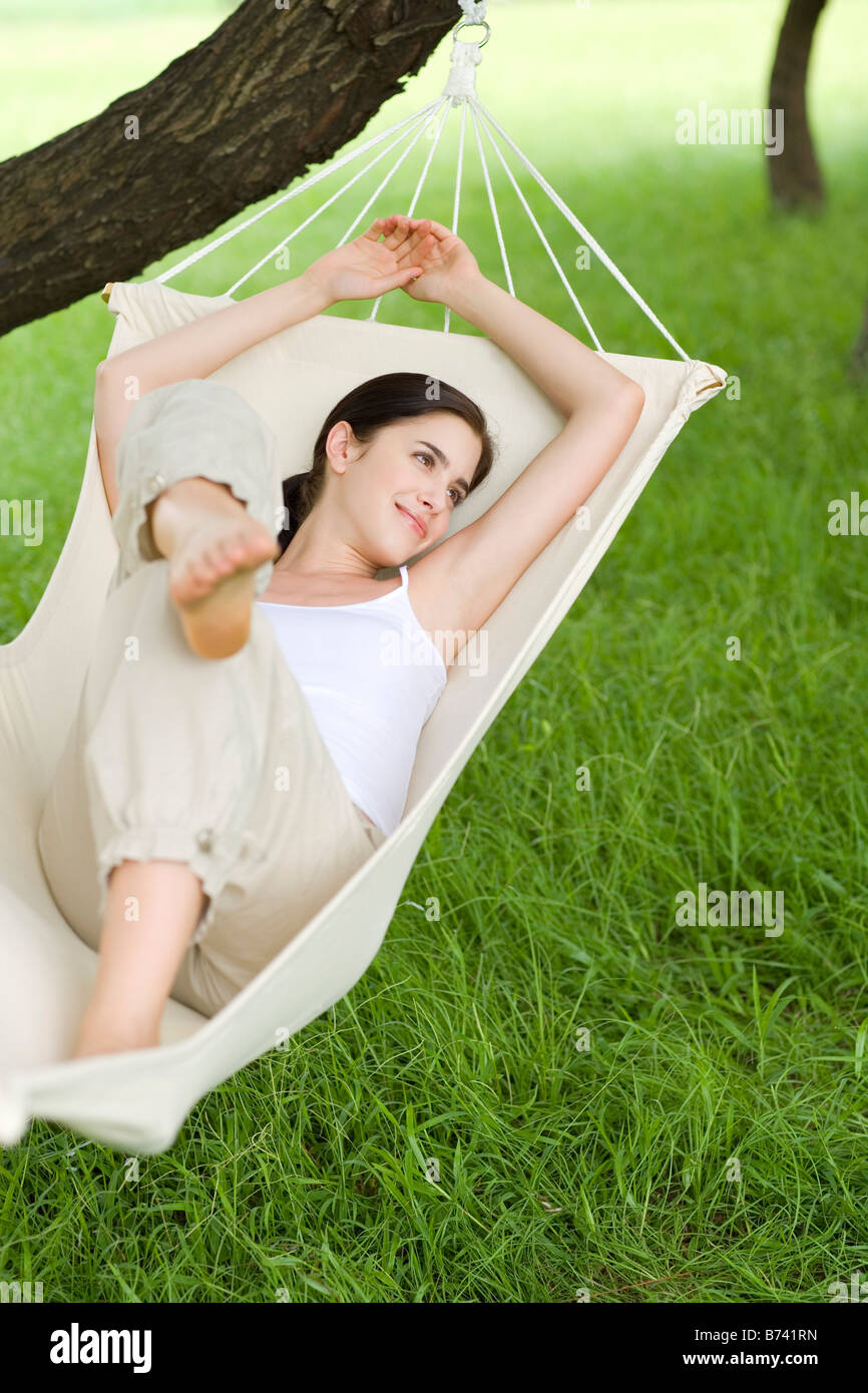 Young woman lying in hammock Stock Photo Alamy