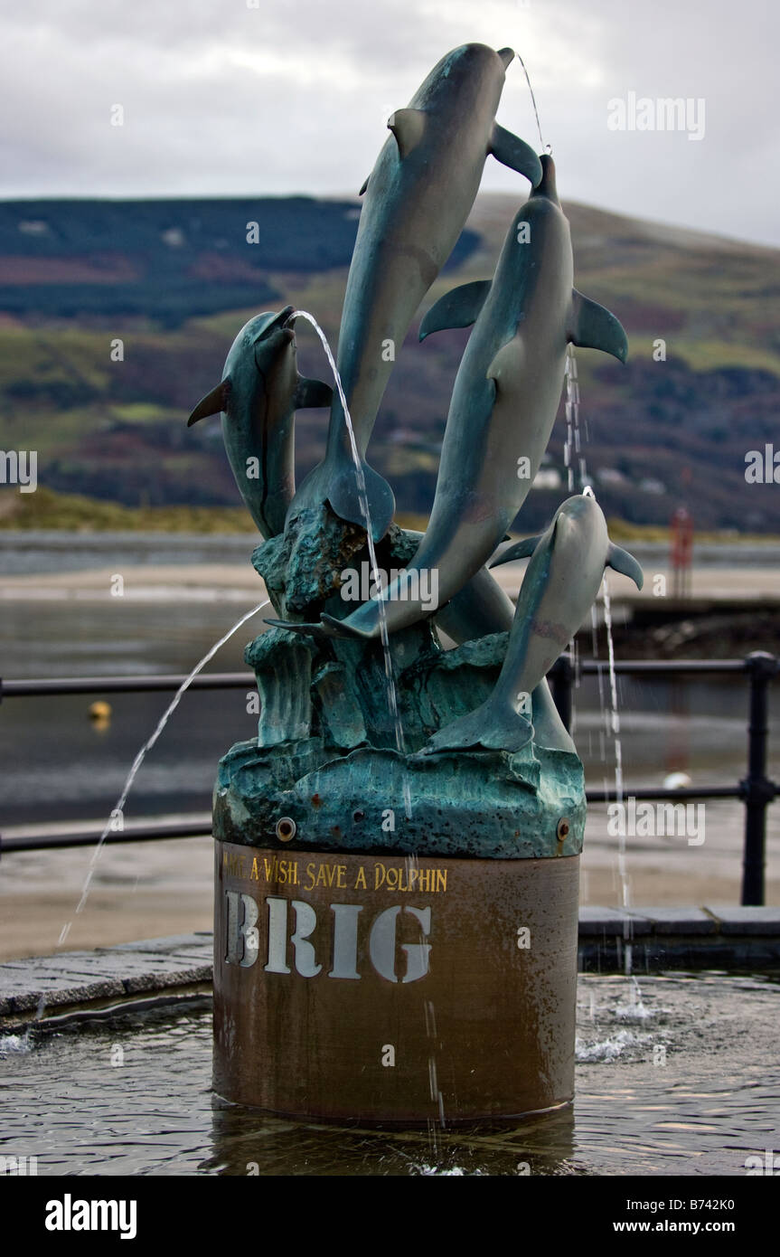 Dolphins wishing well sculpture the harbour at Barmouth Gwynedd North Wales Stock Photo