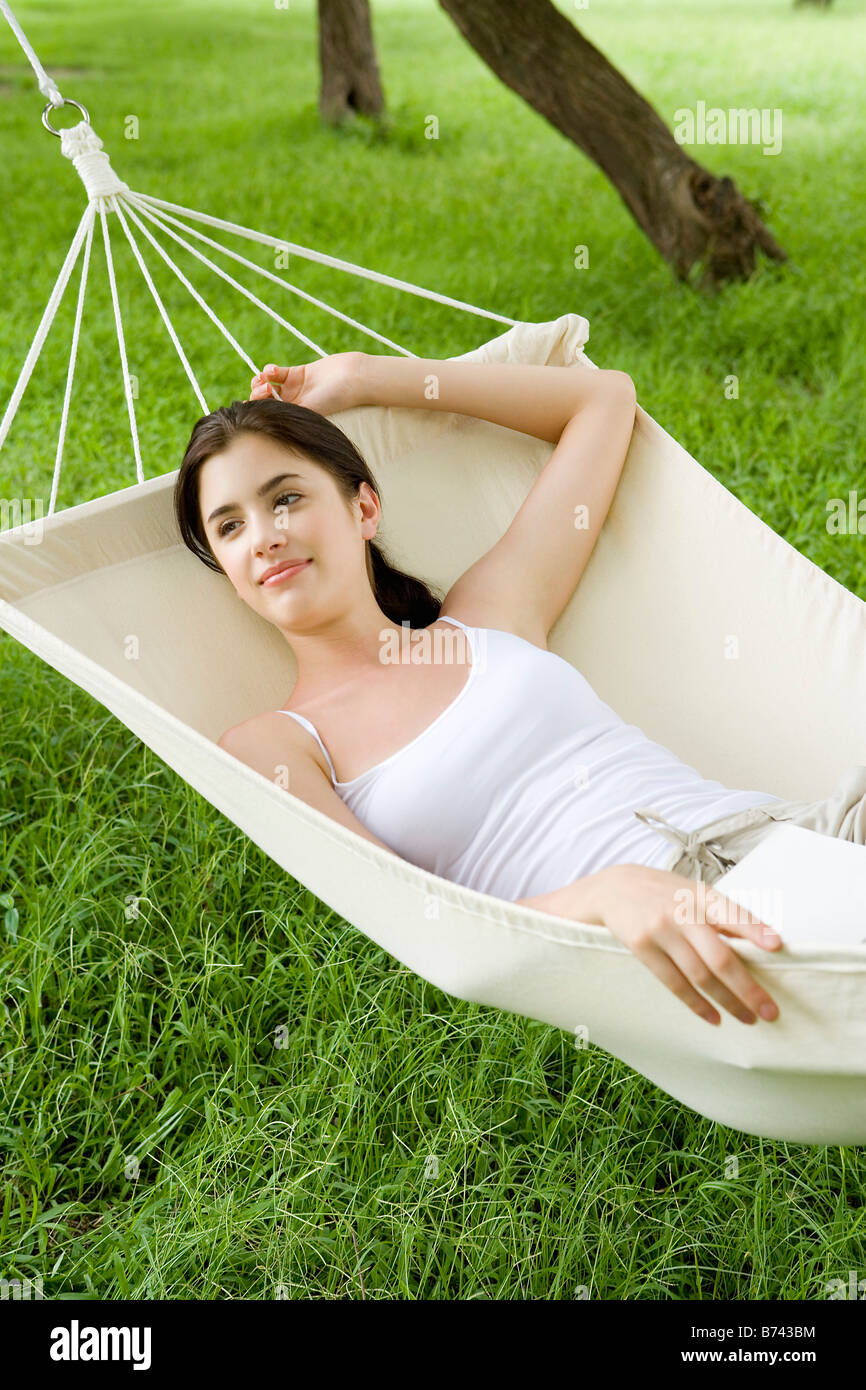 Young woman lying in hammock Stock Photo - Alamy
