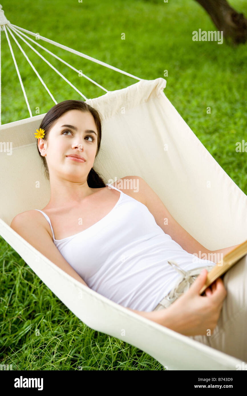 Young woman lying in hammock Stock Photo - Alamy