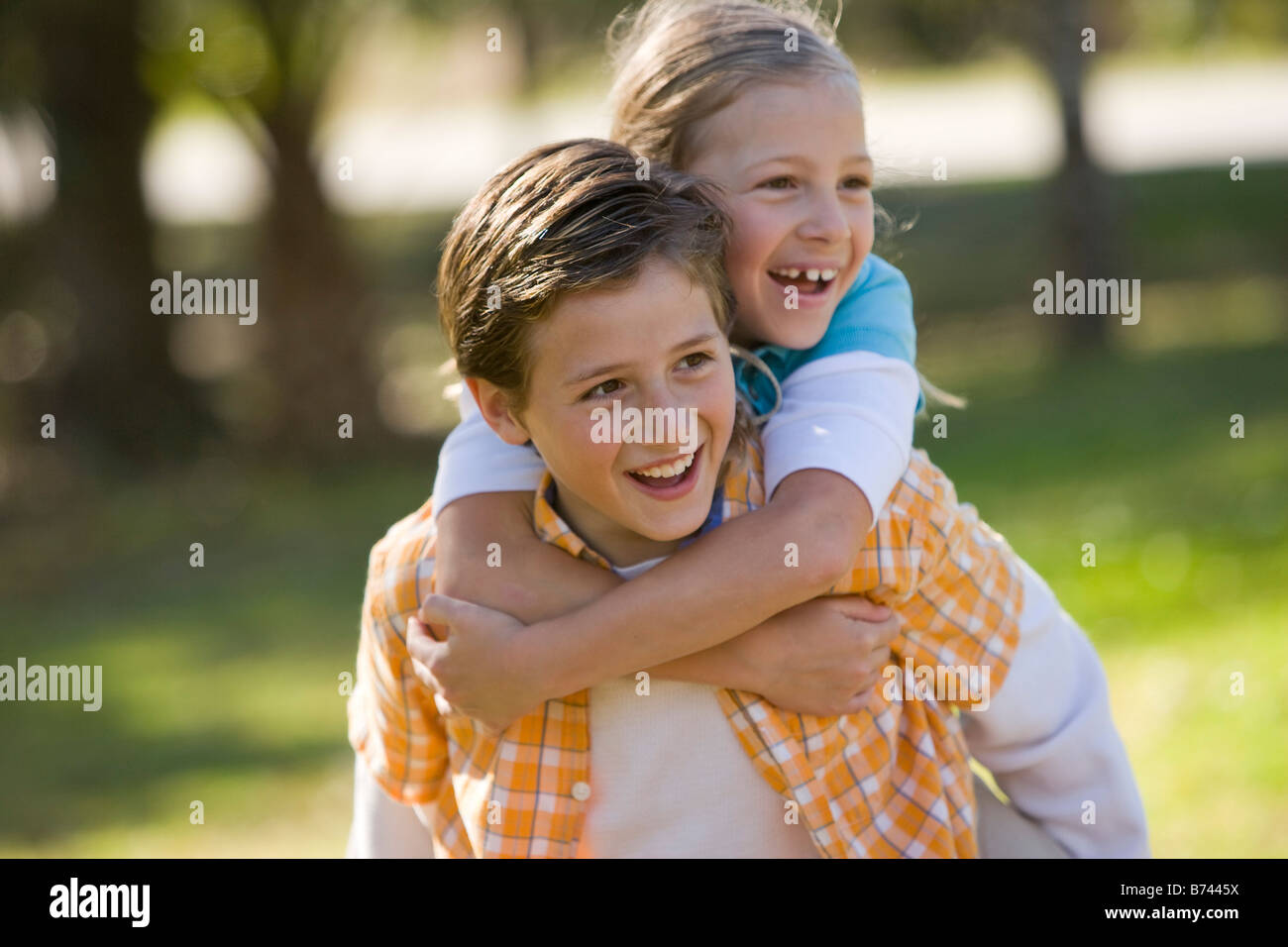 Boy Giving Piggyback Ride To Twin Sister Stock Photo - Image of game,  friend: 233593328