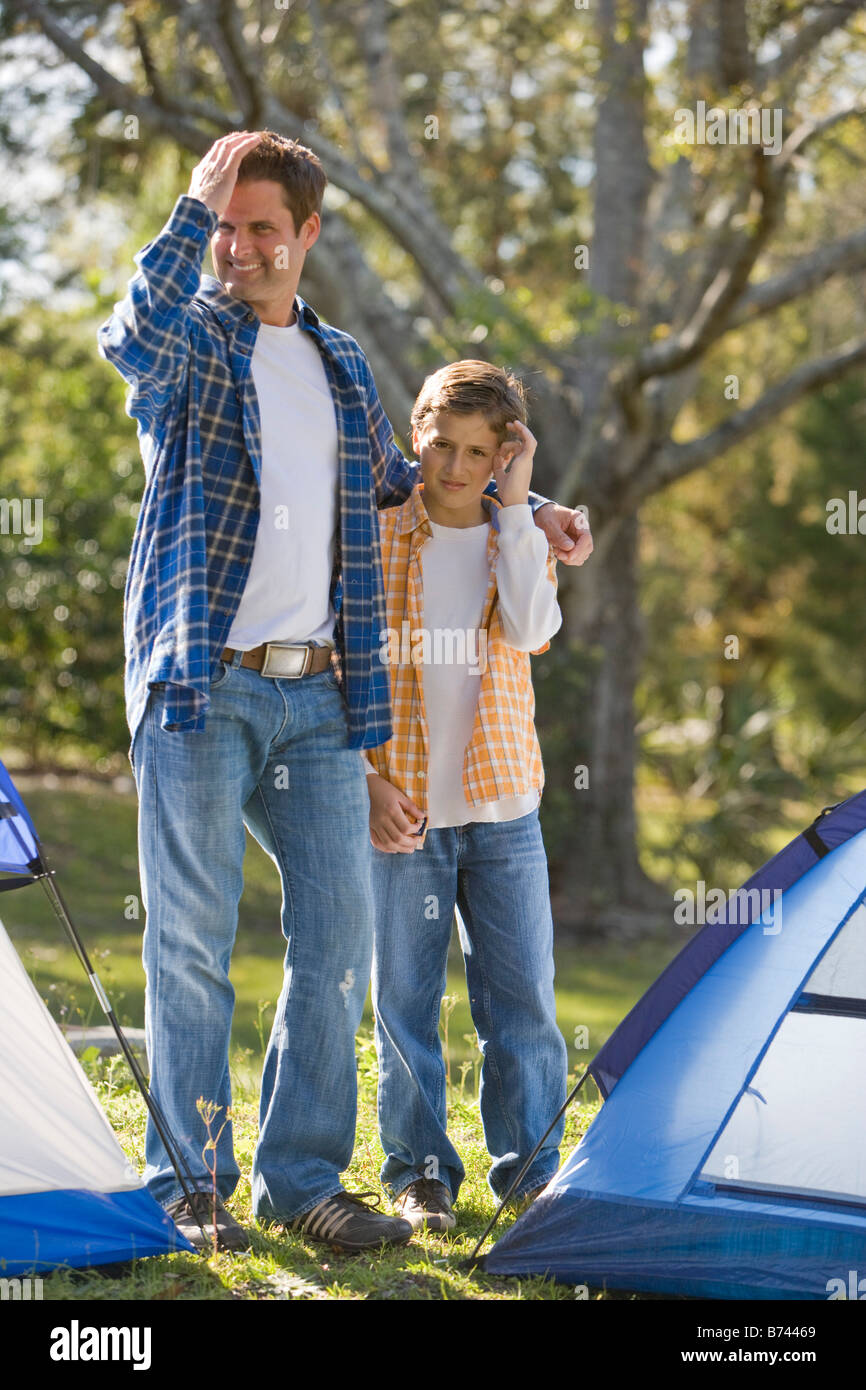 Father and son on camping trip standing beside tents Stock Photo - Alamy