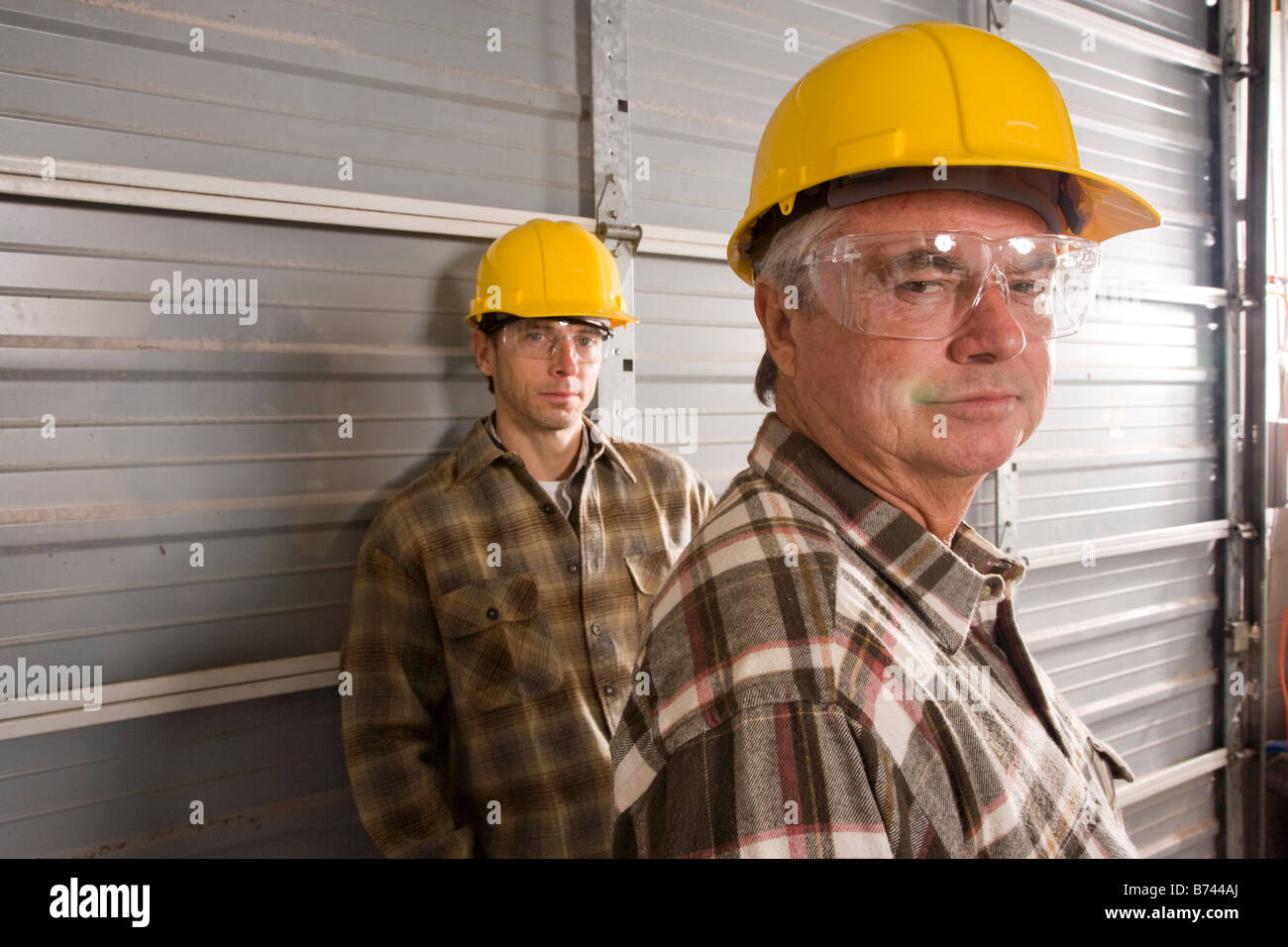 Male construction workers wearing hard hats Stock Photo Alamy