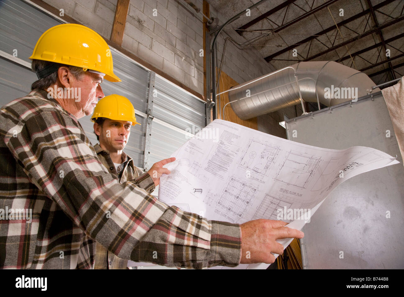 Workmen wearing hard hats standing hi-res stock photography and images ...