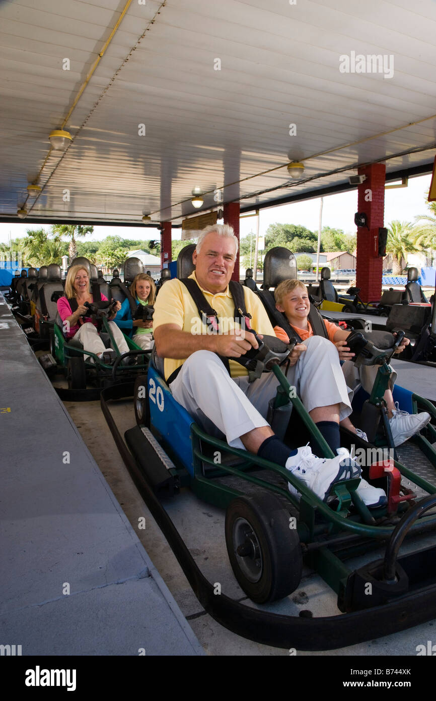 Family riding go-carts at an amusement park Stock Photo - Alamy