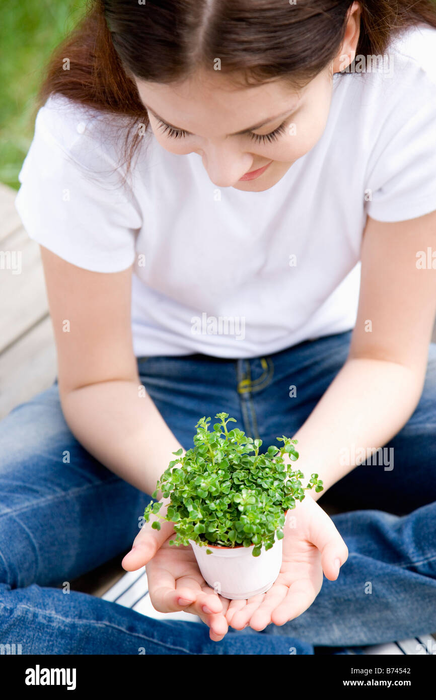 Young woman holding potted plant Stock Photo - Alamy