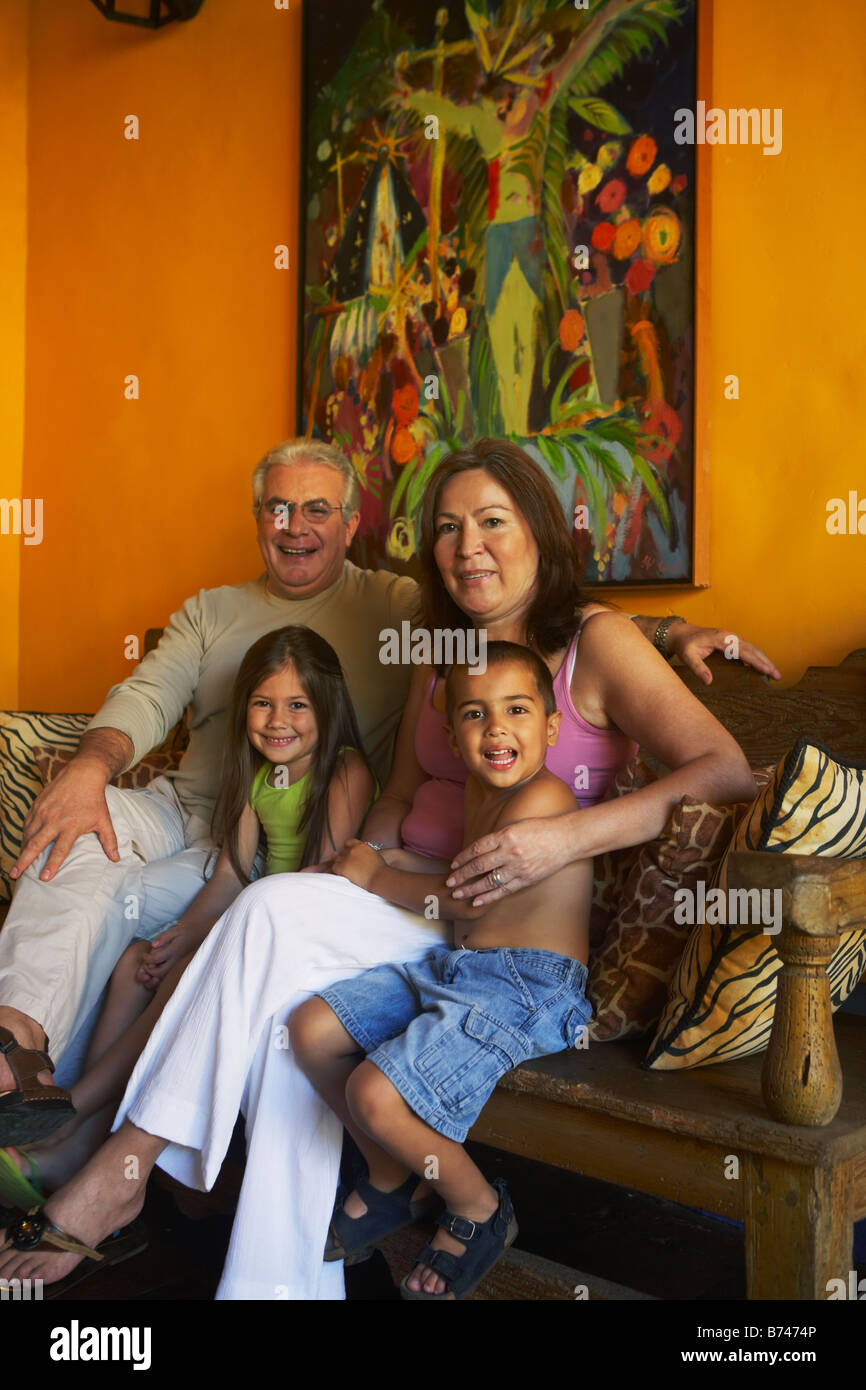 Hispanic grandparents sitting with grandchildren Stock Photo
