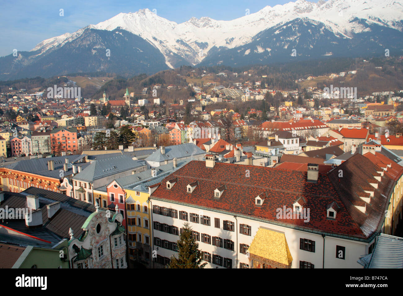 ppanoramic view of Innsbruck with the Golden roof and snow covered mountains in the background Stock Photo
