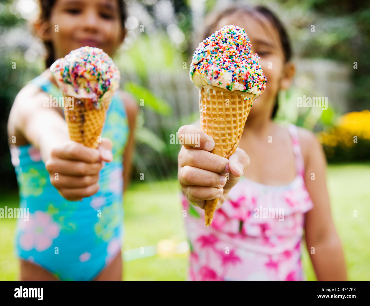 Hispanic girls eating ice cream cones Stock Photo Alamy