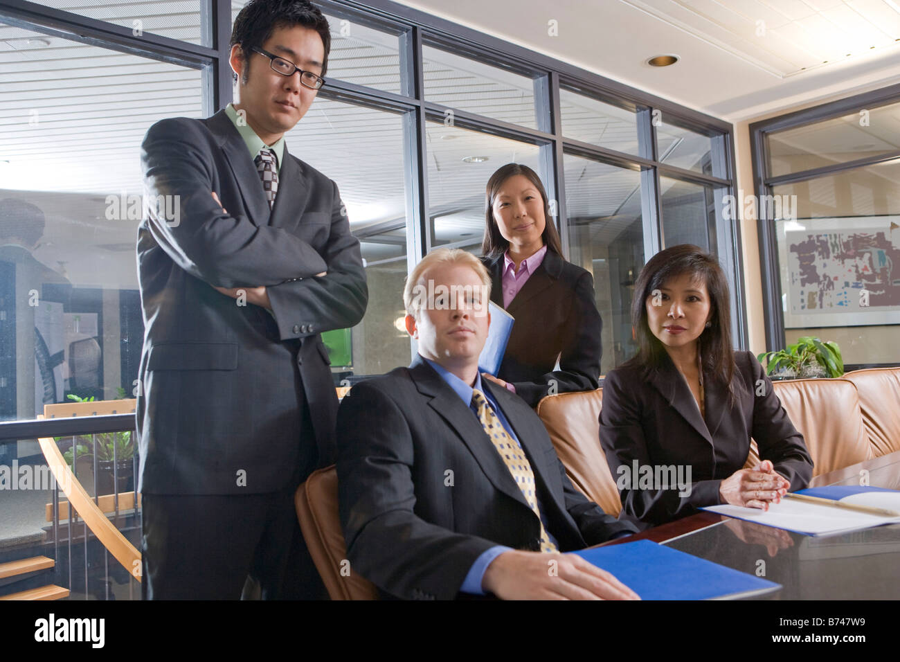 Caucasian businessman in boardroom with Asian executives Stock Photo